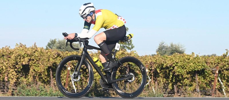 Johannes on the bike leg of a triathlon, riding past vineyards